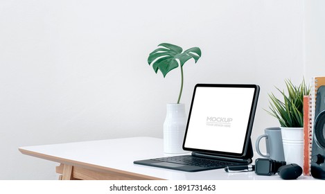 Mockup creative workspace with blank screen tablet and gadget on white top table. - Powered by Shutterstock