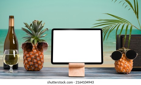 Mockup Digital Tablet And Summer Drinks On Wooden Table With Tropical Beach In Background. Summer Holiday Concept