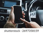 Mockup of driver hand using smartphone in car.