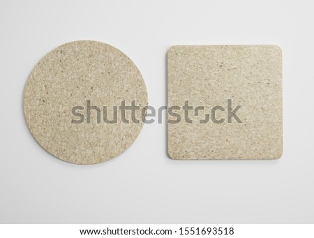 Mockup of empty blank beer drink cork coasters in studio environment on bright white background