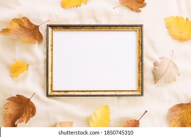 Mockup empty frame on a light background with scattered fallen autumn leaves