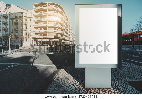 Mockup of empty information poster in urban
settings near urban roads; a blank vertical street banner template
on the sidewalk the end of an alleyway; a billboard placeholder
mock-up on paving-stone
