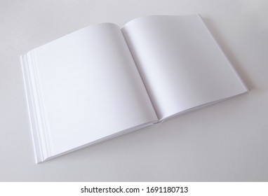 Mockup Of An Empty Open Book In Square Format. Template For Design.