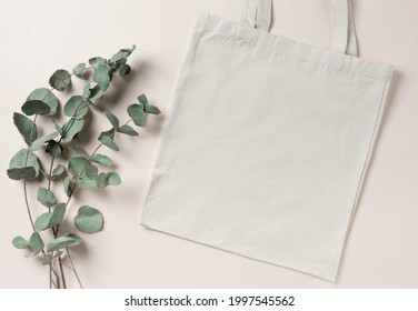 Mockup empty template White cream shopping bag for your design, eco friendly, zero waste with copy space. Eucalyptus branches. Flat lay