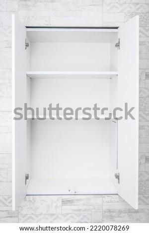 Mockup Empty white open cabinet with shelves in bathroom. shelves for product display, clean white cabinet, light grey wall paint, white wood. vertical image