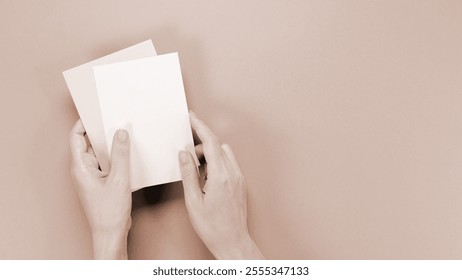 mockup envelop with empty space for text and design in hand of woman on brown background. Colour of the year Mocha Mousse, greeting card, layout for a slogan - Powered by Shutterstock