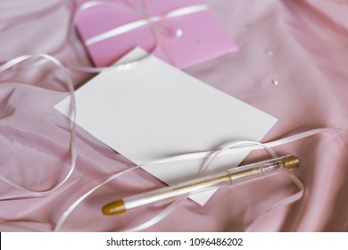 Mockup  envelope and postcard with empty space on pink silk background.