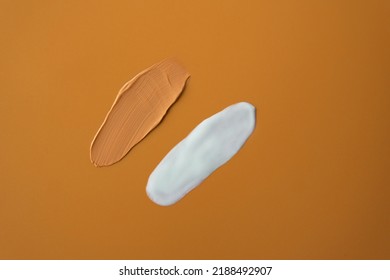 Mockup Facial Skincare Beige Color Tint Uv Sunscreen With SPF 50+ PA++++ Or 30 Two Smear On Soft Plain Orange Isolated Background. Protect Your Skin From Sunlight With Sunblock Reef Safe Ingredient