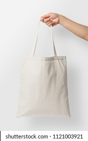 Mockup Of Female Hand Holding A Blank Tote Canvas Bag On Light Grey Background. High Resolution. 