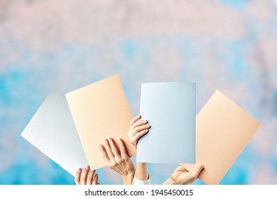 Mockup Of Female Hands Holding Different Empty Colored Cardstock. Copy Space