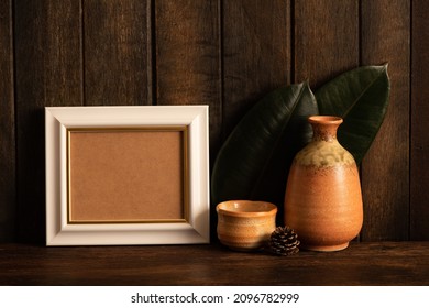 Mockup Frame With Old Japanese Ceramic Sake Bottle And Cup On Wood Background.