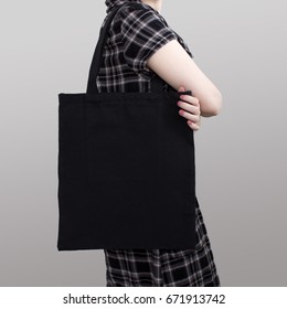 Mock-up. Girl In Dress Carries Black Cotton Tote Bag.