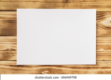 Mockup Of Horizontal White A4 Paper List At Textured Wooden Table Background.