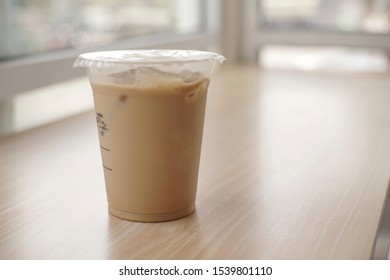 Mockup Of Iced Coffee Milk In A Plastic Cup Inside A Cafe