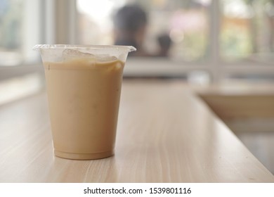 Mockup Of Iced Coffee Milk In A Plastic Cup Inside A Cafe