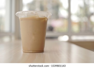 Mockup Of Iced Coffee Milk In A Plastic Cup Inside A Cafe