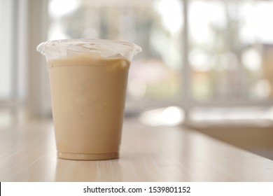 Mockup Of Iced Coffee Milk In A Plastic Cup Inside A Cafe