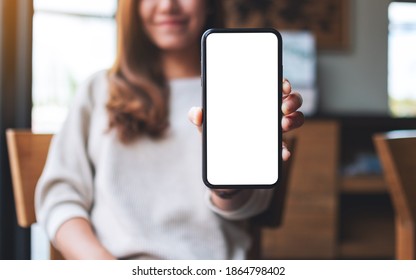 Mockup Image Of A Beautiful Asian Woman Holding And Showing A Mobile Phone With Blank White Screen