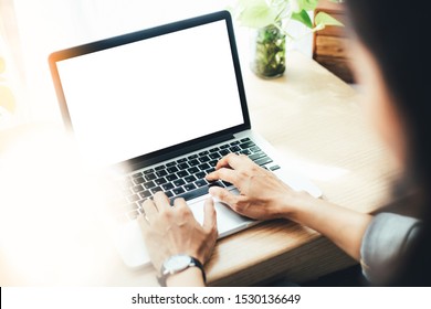 mockup image blank screen computer with white background for advertising text,hand man using laptop contact business search information on desk in office.marketing and design