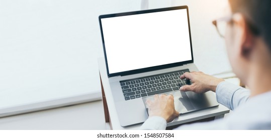 mockup image blank screen computer with white background for advertising text,hand man using laptop contact business search information on desk in office.marketing and creative design
