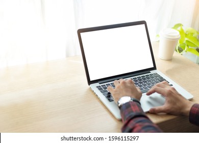 mockup image blank screen computer with white background for advertising text,hand man using laptop contact business search information on desk at home office.marketing and creative design