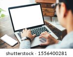 mockup image blank screen computer,cell phone with white background for advertising text,hand man using laptop texting mobile contact business search information on desk in office.marketing and design