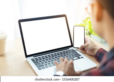 Mockup Image Blank Screen Computer,cell Phone With White Background For Advertising Text,hand Man Using Laptop Texting Mobile Contact Business Search Information On Desk In Office.marketing And Design