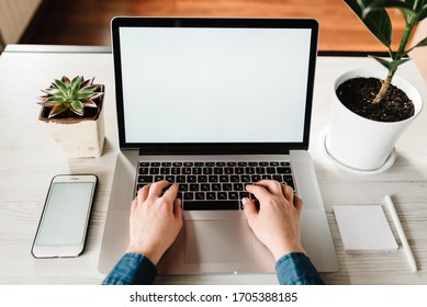Mockup image blank screen laptop computer, cell phone with white background for advertising text. Hands woman using laptop on table. Writing, typing. Freelance concept. Work home. Marketing, design. - Powered by Shutterstock
