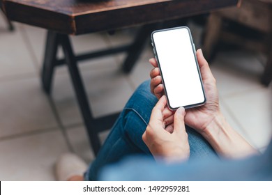 Mockup Image Blank White Screen Cell Phone.woman Hand Holding Texting Using Mobile On Desk At Coffee Shop. Background Empty Space For Advertise Text. Contact Business,people Communication,technology