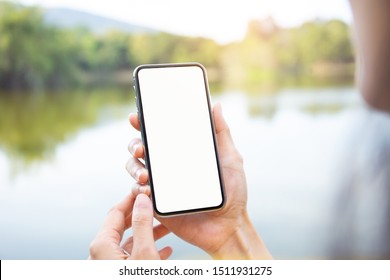 Mockup Image Blank White Screen Cell Phone.man Hand Holding Texting Using Mobile At Outdoor In The Park. Background Empty Space For Advertise Text. Contact Business,people Communication,technology 