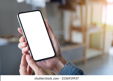 Mockup Image Blank White Screen Cell Phone.men Hand Holding Texting Using Mobile On Desk At Home Office. Background Empty Space For Advertise Text.people Contact Marketing Business And Technology 