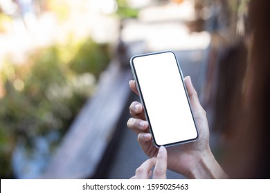 Mockup Image Blank White Screen Cell Phone.man Hand Holding Texting Using Mobile At Outdoor.background Empty Space For Advertise Text.people Contact Marketing Business,technology 