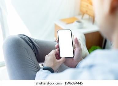 Mockup Image Blank White Screen Cell Phone.man Hand Holding Texting Using Mobile On Desk At Home Office.background Empty Space For Advertise Text.people Contact Marketing Business,technology 