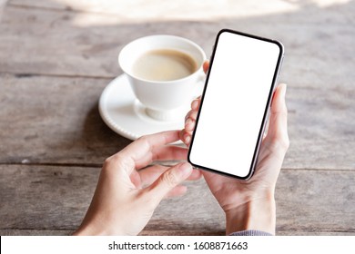 Mockup Image Blank White Screen Cell Phone.man Hand Holding Texting Using Mobile On Desk At Coffee Shop.background Empty Space For Advertise Text.people Contact Marketing Business,technology 