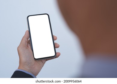 Mockup Image Of Business Man Hand Holding Mobile Smart Phone With  Blank White Screen Template, Back View, Close Up