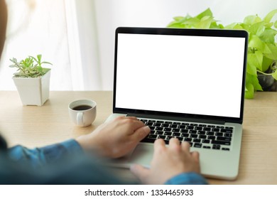 mockup image computer hand typing with blank screen for text,man using laptop contact business and searching information in workplace on desk in office.design creative work space on wooden desktop - Shutterstock ID 1334465933