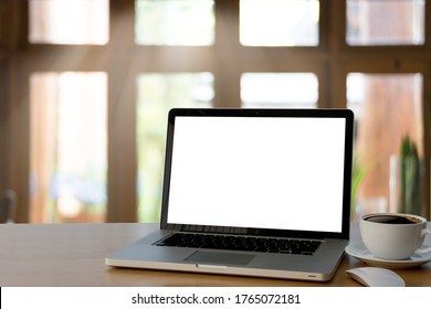 Mockup Image Of Laptop Blank Screen For Texture Display Product Presentation With Coffee Cup On Wood Workplace Table,at Office Blurred Background.