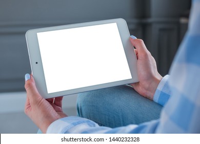 Mockup Image: Over Shoulder Close Up View Of Woman Looking At Modern Digital Tablet Computer Device With White Blank Screen. Mock Up, Copyspace, Leisure Time, Template And Technology Concept