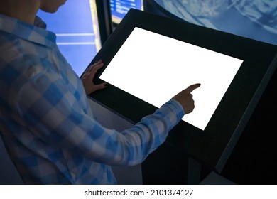 Mockup Image - Woman Hand Touching White Empty Interactive Touchscreen Display Kiosk In Dark Room Of Modern Technology Museum. Mock Up, Template, Scifi, Education, Futuristic And Technology Concept