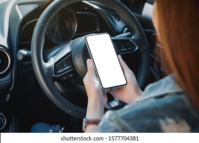 Mockup Image Of A Woman Holding And Using Mobile Phone With Blank Screen While Driving Car