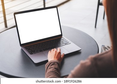 Mockup Image Of A Woman Using And Touching On Laptop Computer Touchpad With Blank White Desktop Screen On The Table