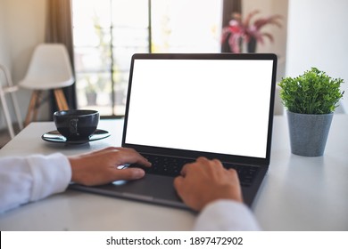 Mockup Image Of A Woman Using And Typing On Laptop Computer With Blank White Desktop Screen