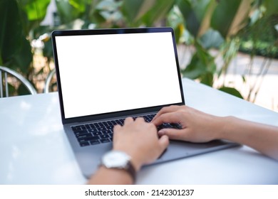 Mockup Image Of A Woman Using And Typing On Laptop Computer With Blank White Desktop Screen