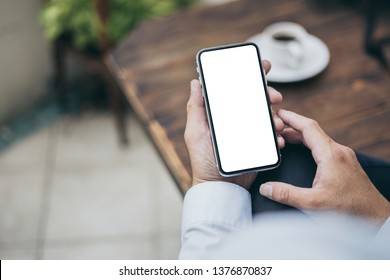 Mockup Image Of Woman's Hand Holding Using White Mobile Phone At Outdoor With Copy Space,blank Screen For Text.concept For Business,people Communication,technology Electronic Device. Modern Life