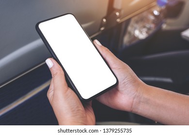 Mockup Image Of Woman's Hand Holding A Black Smart Phone With Blank Desktop Screen In Cabin