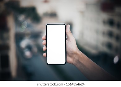 Mockup Image Of A Woman's Hand Holding Black Mobile Phone With Blank Desktop Screen
