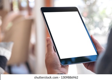 Mockup Image Of A Woman's Hands Holding Black Tablet Pc With Blank White Screen While Sitting In Cafe