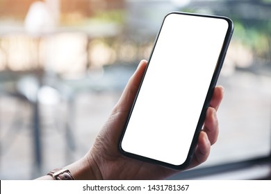 Mockup Image Of Woman's Hands Holding Black Mobile Phone With Blank Desktop Screen