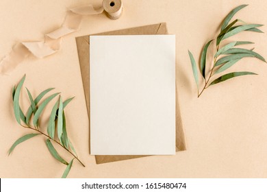 Mockup invitation, blank greeting card and green leaves eucalyptus. Flat lay, top view. - Shutterstock ID 1615480474