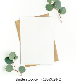 Mockup invitation, blank greeting card and green leaves eucalyptus. Flat lay, top view. - Shutterstock ID 1886372842